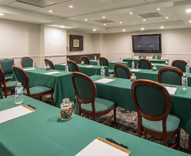 Meeting room setup classroom style with green tablecloths