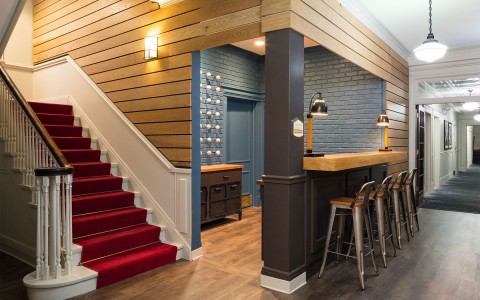 hotel lobby with a bar counter and the stairs 