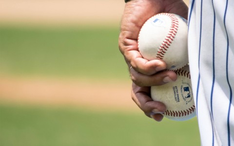 player holding two baseballs