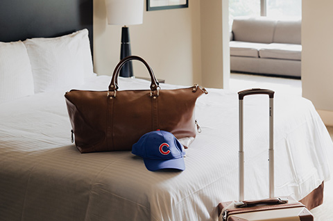 hat and bag on bed in hotel room