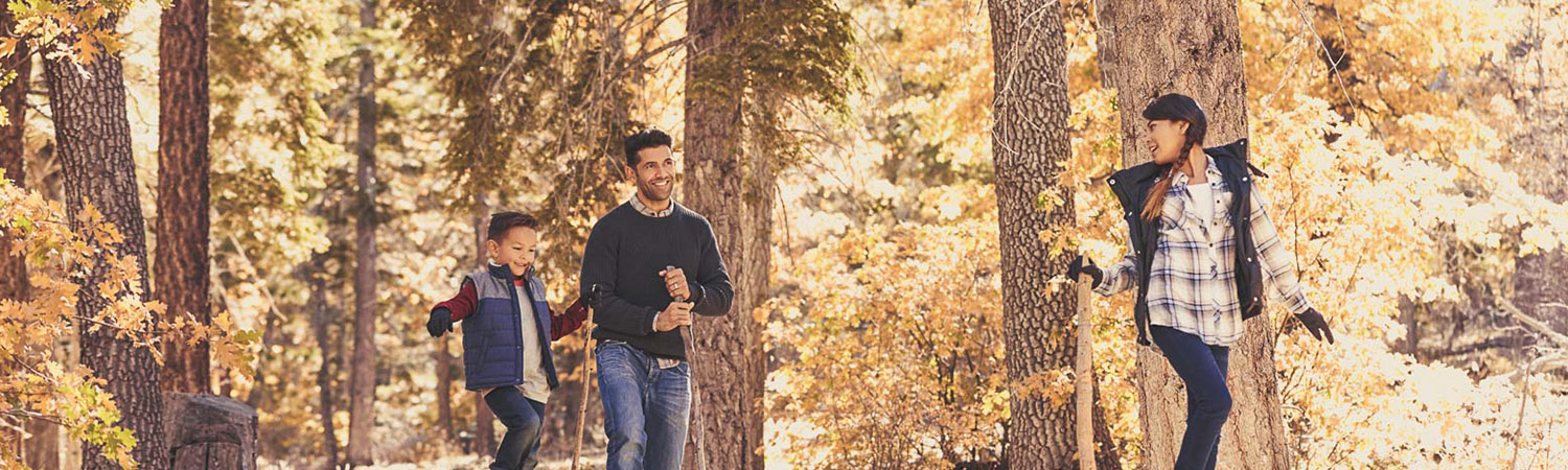 family hiking through the woods in the fall