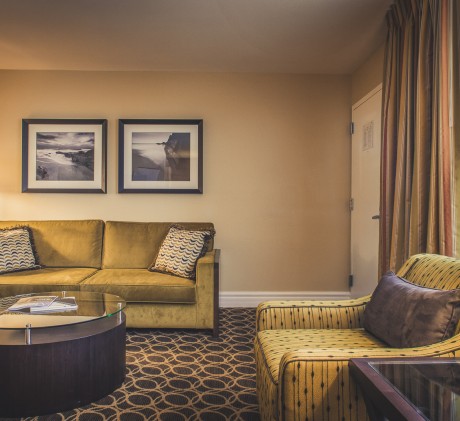 guestroom living room with gold couches and coffee table