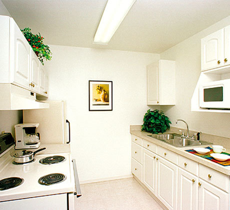 Kitchen with stove, oven, sink, refrigerator, and microwave