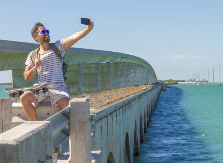 Young man traveling and taking a selfie