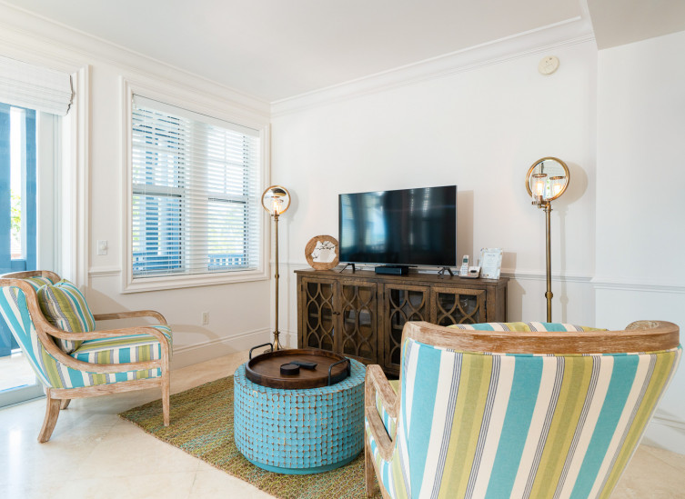 Living space with colorful chairs, blue tile coffee table & tv