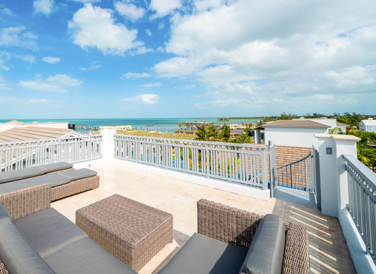 Room balcony with wicker chairs and view of marina