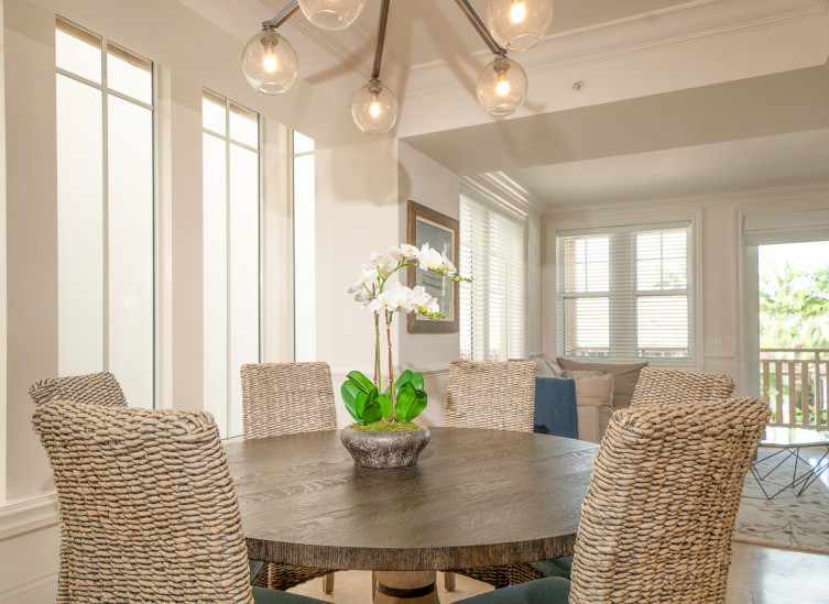 close up of dining table with wicker chairs