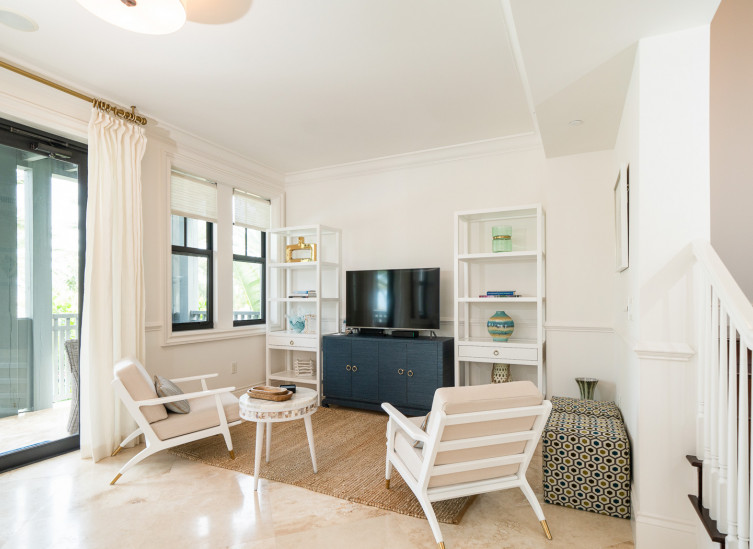 Living space with casual style beach chairs, blue and white furniture and tv