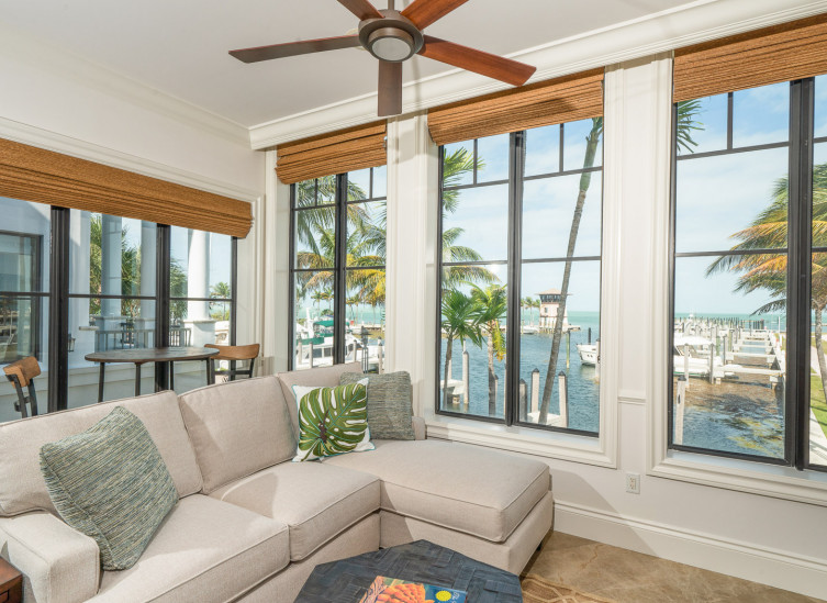 Room living space with large window panel view of marina