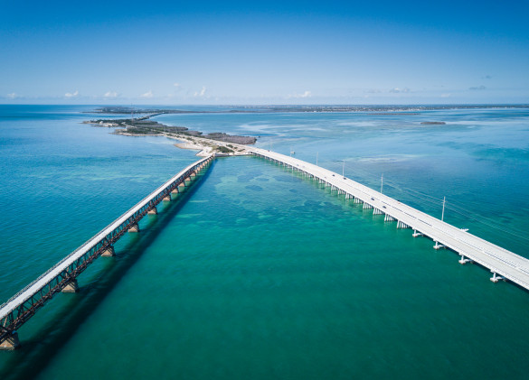 aerial photo of both old and new seven mile bridges over blue green ocean waters