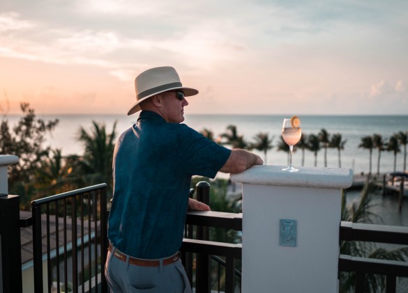 man admiring view at marlin bay with a tropical cocktail