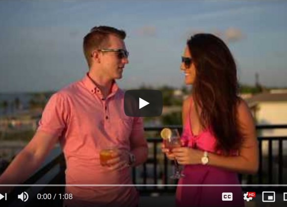 video image of couple enjoying a drink on the balcony of a vacation home