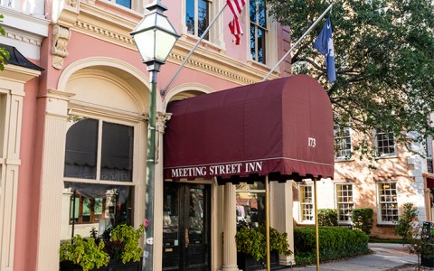 The dark red awning covering the entrance to the meeting street inn.