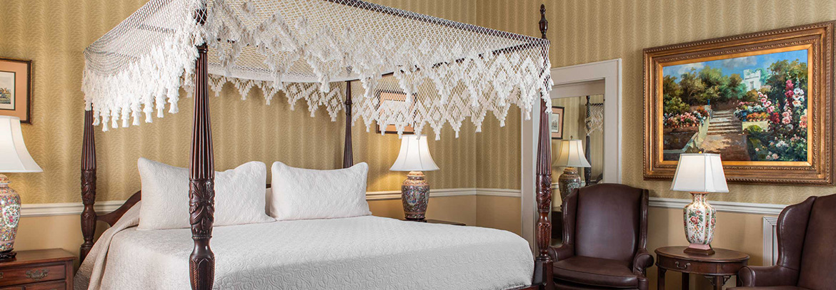 A large bed with a lace canopy.