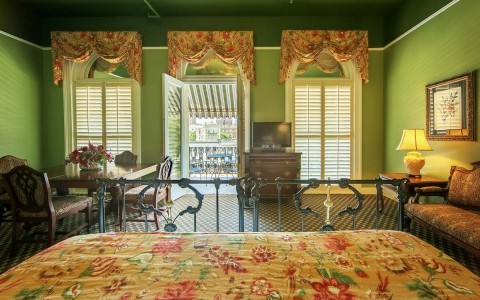 a guest room with green walls