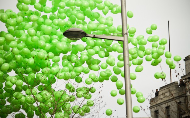 Green Parade Balloons. street filled with hundreds of green balloons