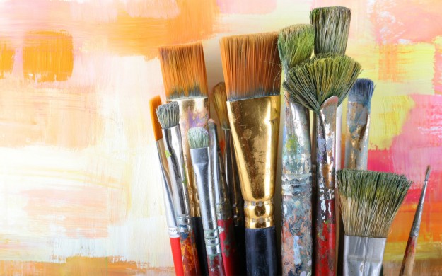set of paint brushes that have been heavily used