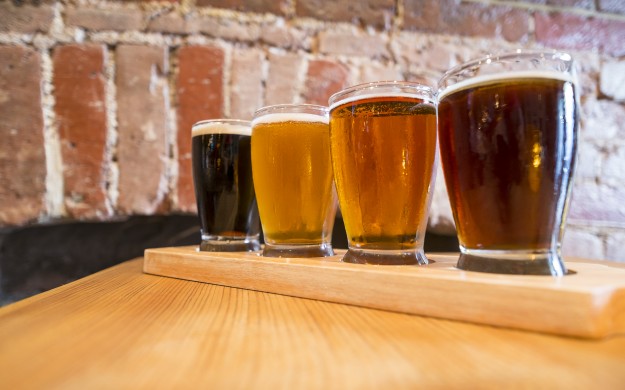 flight of beers on a bar