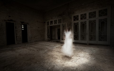 what appears to be a ghost of a women in a dilapidated building