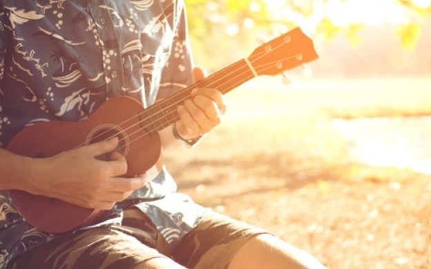 man playing the ukulele