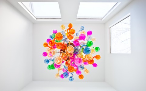 view from underneath colorful glass squiggle chandelier 