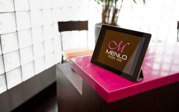 ipad on the check in desk with Menlo logo displayed.