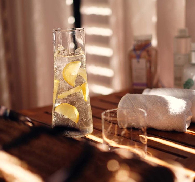 pitcher of iced water with lemons prepared for a guest at the spa