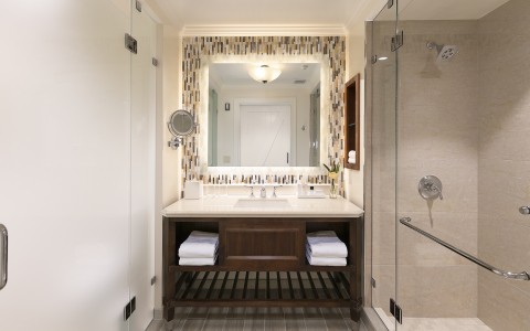Bathroom with a large mirror with a shower stall