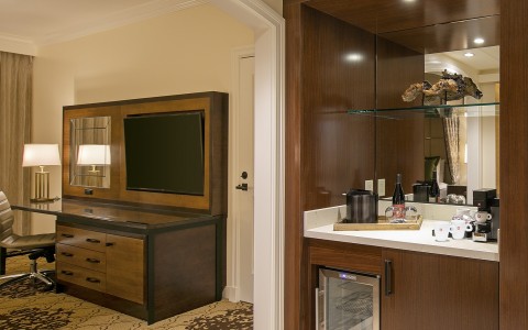 Hotel room with a desk and mini bar 