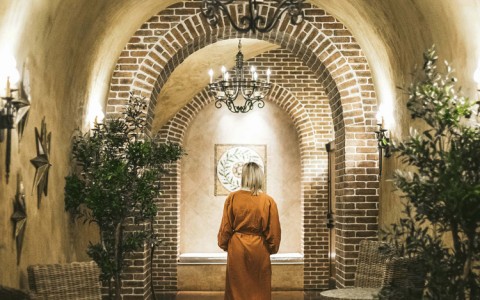 Woman wearing a robe walking around a spa 