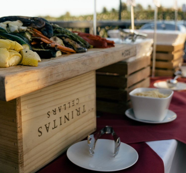 close up of an outdoor buffet set up featuring grilled vegetables harvested from meritage garden