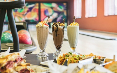 A variety of milkshakes and dishes in a bowling alley 