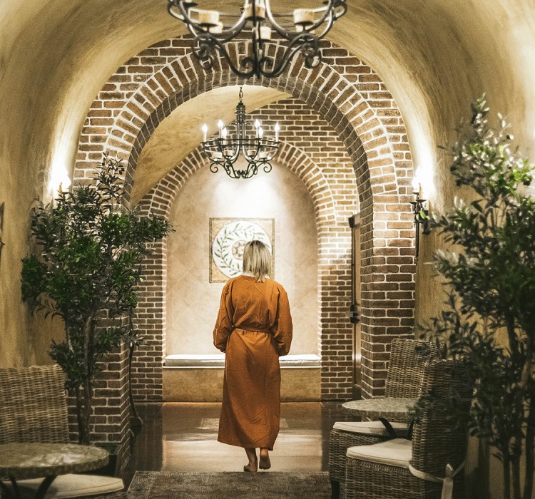 Woman in a robe walking around a spa 