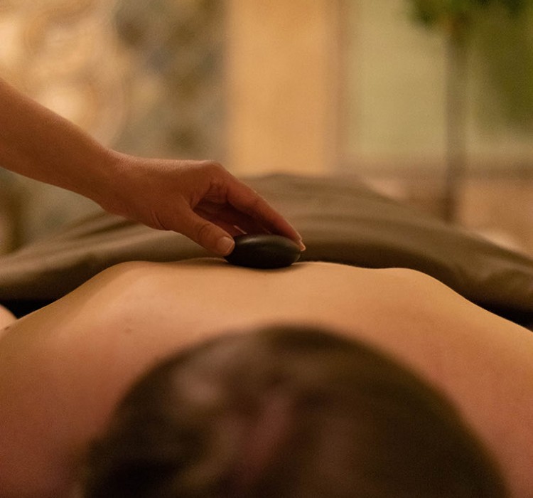 Woman laying down while getting a spa treatment 
