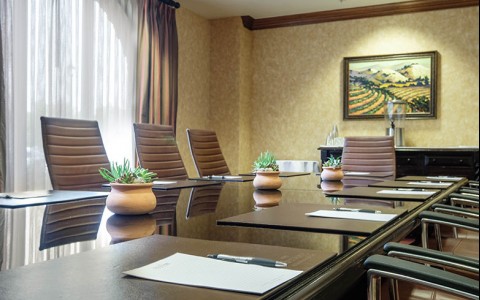 Meeting room with a brown table and chairs 