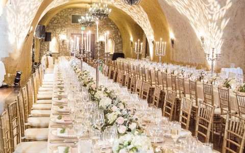 Beautiful wedding venue inside a cave with two long set up tables 