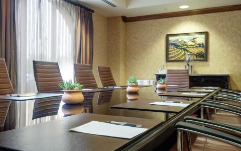 Long conference room with brown chairs