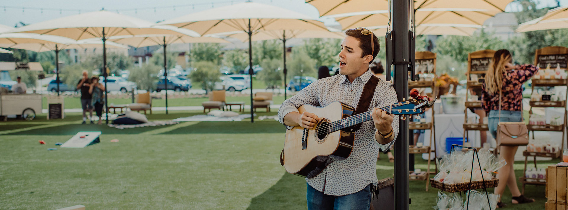 Man playing the guitar on the lawn