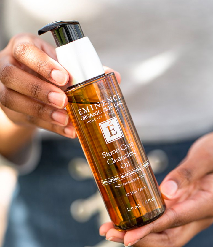 woman holding a bottle of skin care