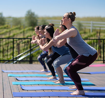 Group of women doing yoga on an terrace