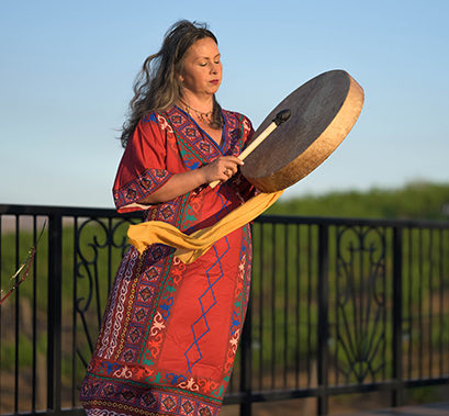Woman wearing a red dress playing an instrument