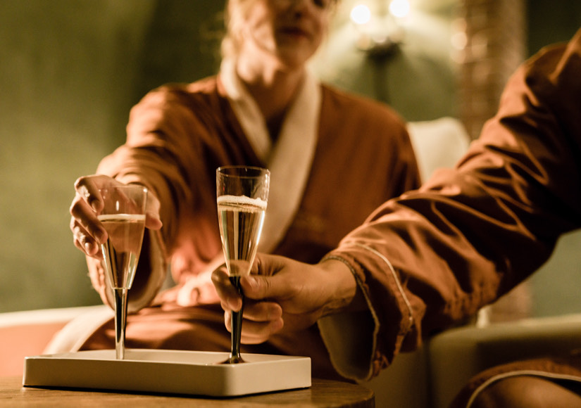 couple enjoying champagne while they relax at the spa