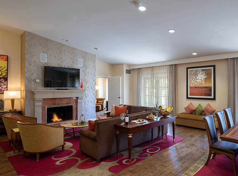 Large and cozy living room with a lit fire place