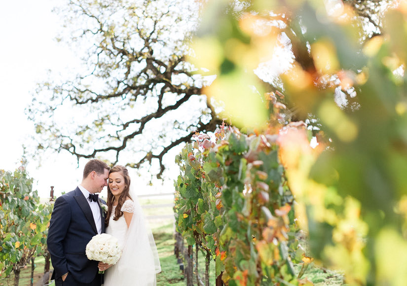 Married couple embracing at a vineyard