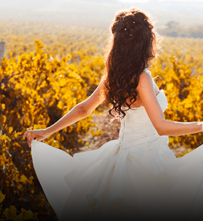 women in white dress dancing through field