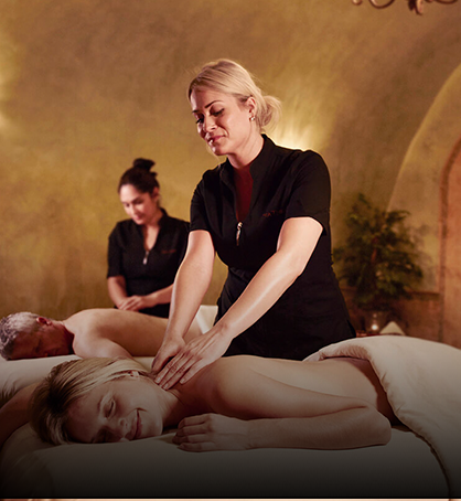 women giving a massage to hotel guest