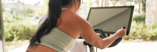 Woman riding an exercise bike