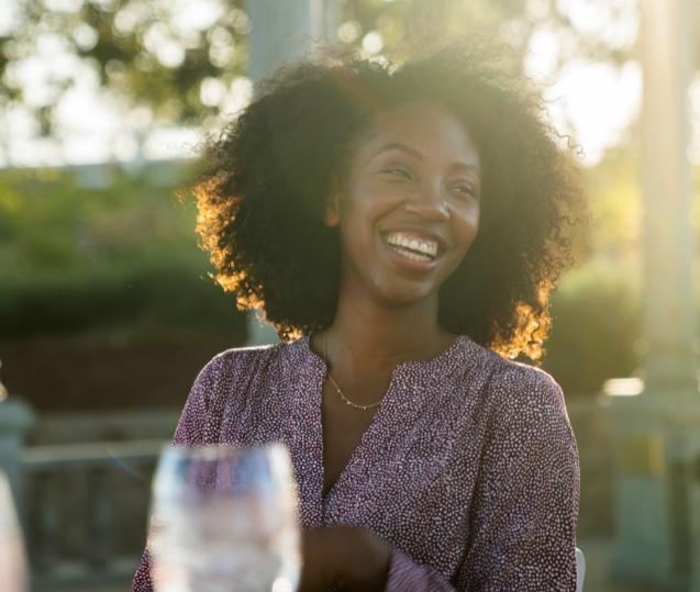 woman smiling at outdoor meeting