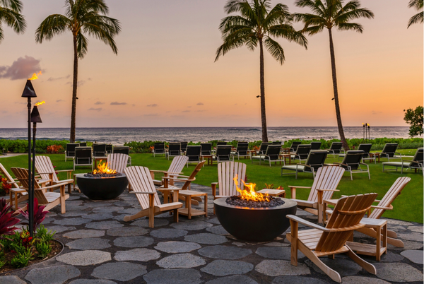 Lawn with chairs and fire-pits facing the beach 