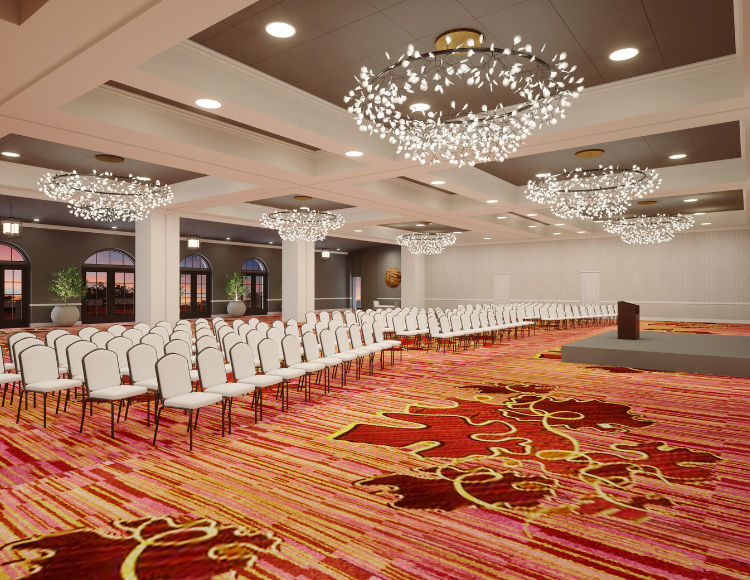 View of Meritage ballroom with white chairs and a multicolor carpet